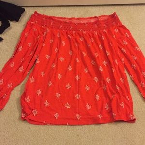 red flower off the should top